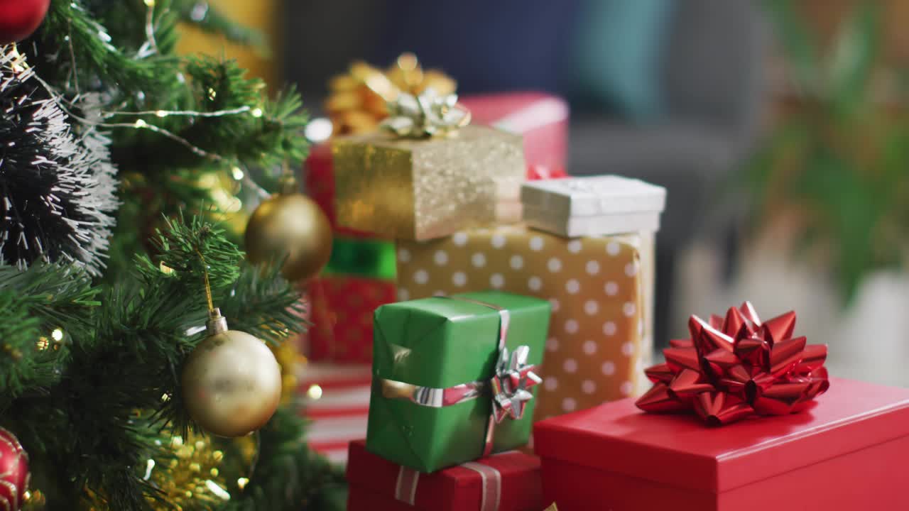 Soft cursive script appearing tracing into pink neon Register over gifts near tree inviting signup