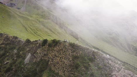 drone shot inside the clouds of hikers in the mountains of cuzco peru