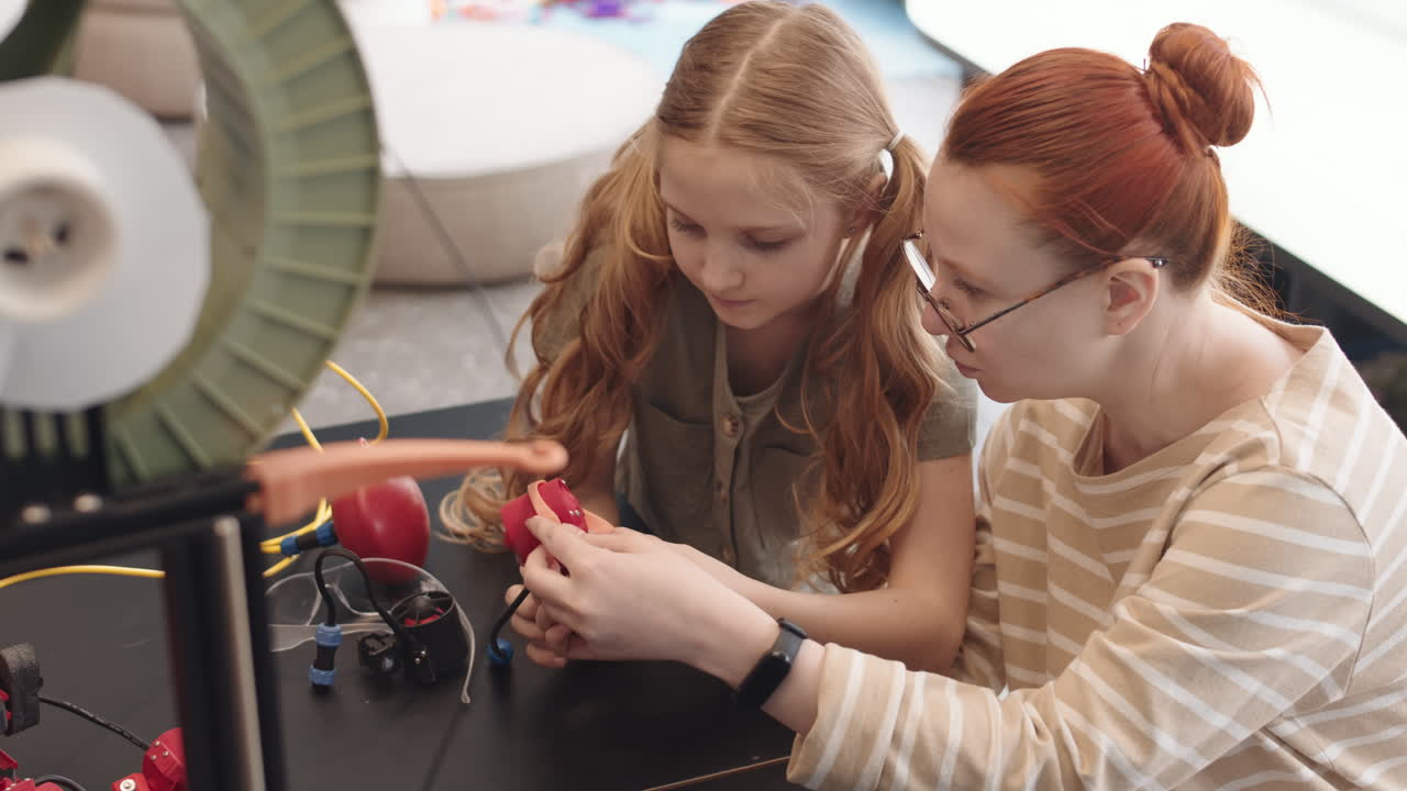 Female Teacher and Intelligent Teenage Girl Building Robot