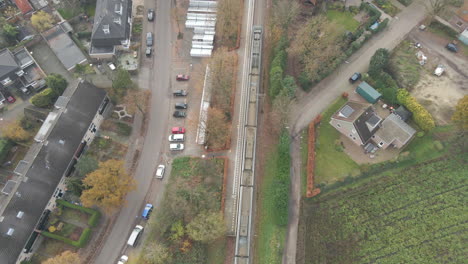 aerial of train stopping at small rural train station