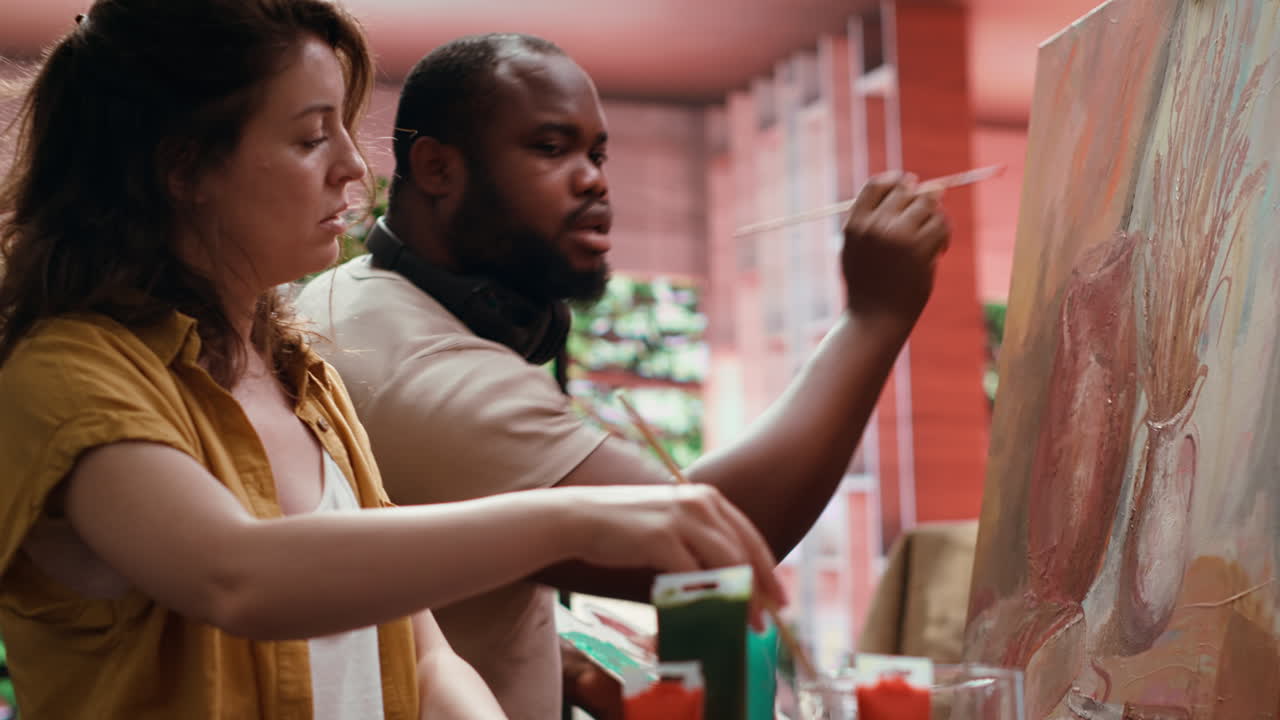 Couple painting together in a studio
