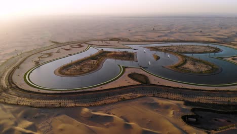 drone shoot of the heart shaped dubai love lake in al qudra during sunset