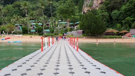 tropical beach resort pier with people