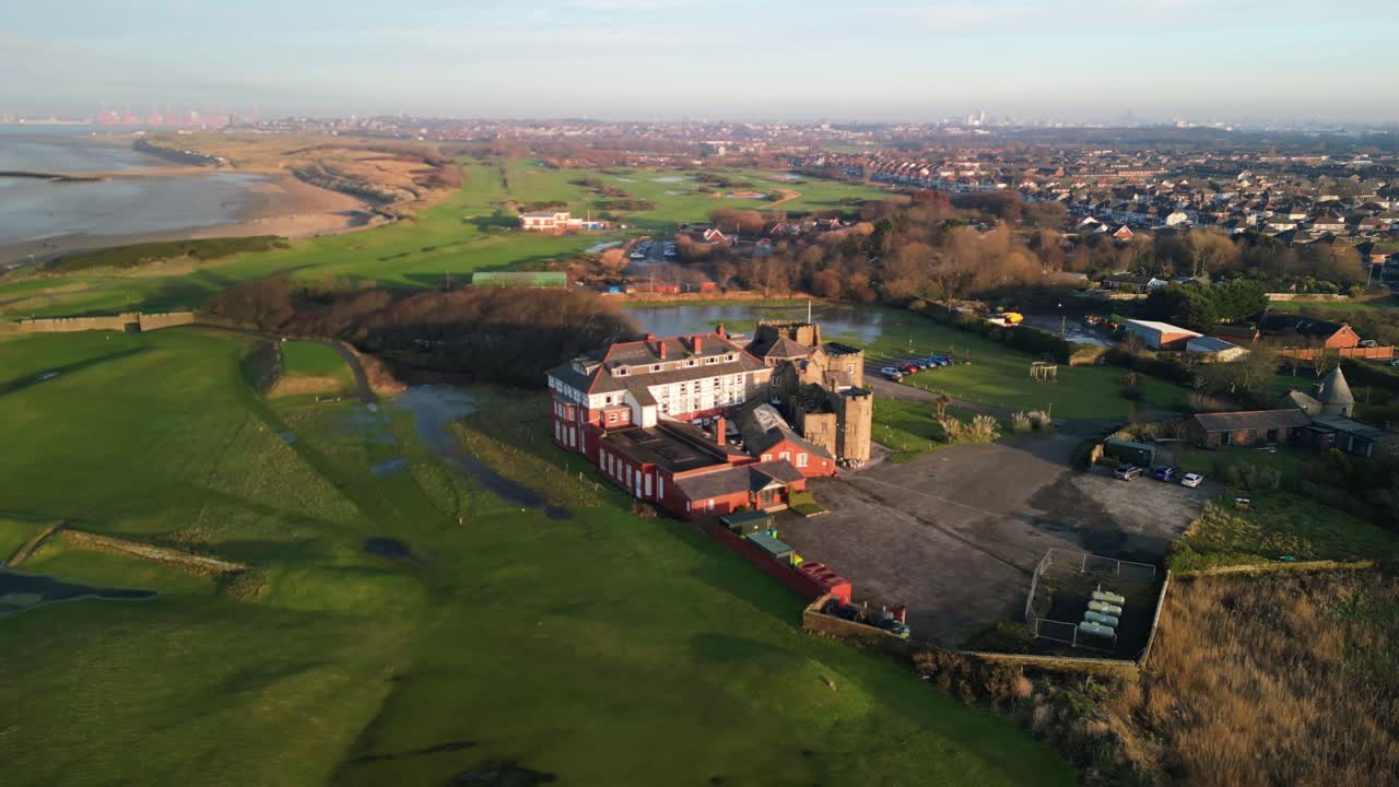 Leasowe Castle and Golf Club aerial drone rotate around on a beautiful winter afternoon at sunset, Wirral - UK