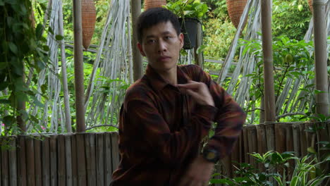 concentrated asian dancer practicing a choreographed freestyle dance in a daytime garden