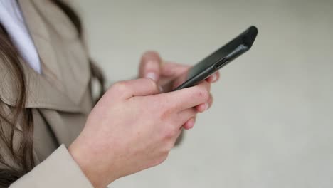 close up shot of female hands texting on phone. side view