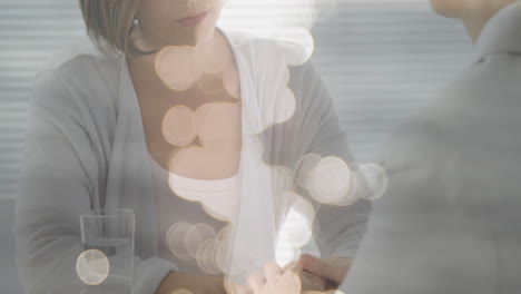 animation of light spots over caucasian woman consulting psychologist