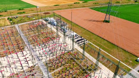 aerial view over powerlines in electric substation - drone shot