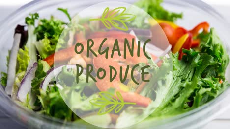 animation of organic produce text in green, over bowl of fresh salad