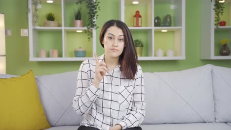 Young-woman-warns-looking-at-the-camera,-expressing-that-she-should-be-careful.