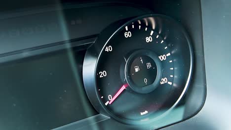 close-up of a car dashboard with speedometer and fuel gauge