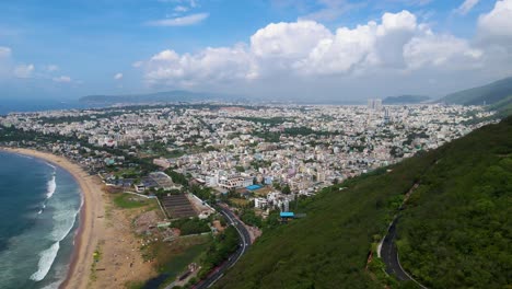 stunning aerial drone shot of vizag, with its vibrant cityscape juxtaposed against the tranquil coastline.