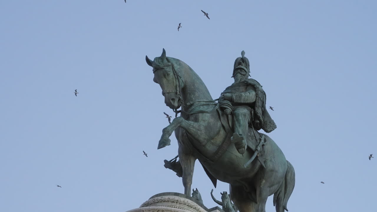 Equestrian statue of Vittorio Emanuele II with birds on the background in slow motion, Rome, Italy