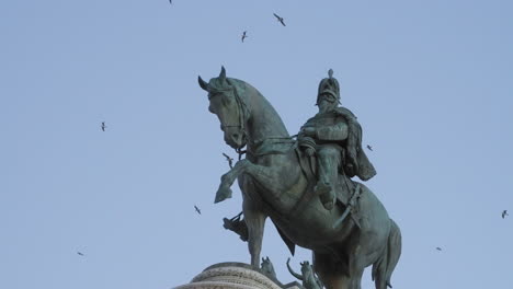 equestrian statue of vittorio emanuele ii with birds on the background in slow motion, rome, italy