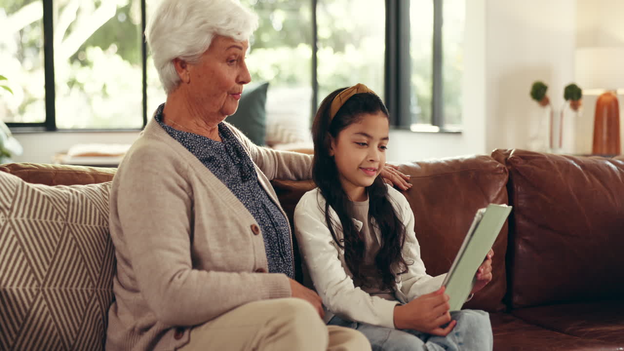 할머니와 손녀가 함께 태블릿을 사용합니다.