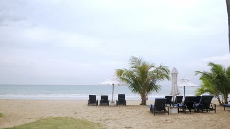 Luxury-beach-lounge-beds-with-umbrella-on-white-sand-beach-with-coconut-tree-in-thailand-with-sunny-summer-weather-and-clear-blue-sky-1