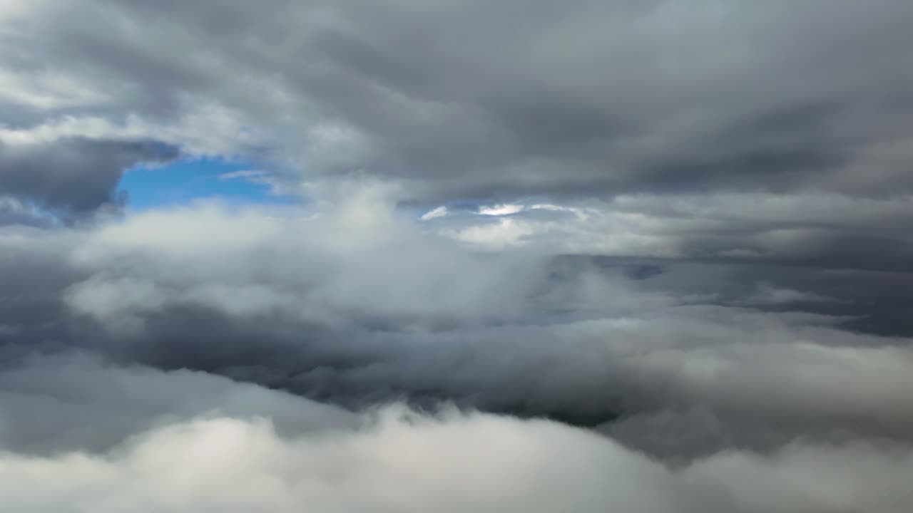 immersive pilot’s eye POV view while flying through a dreamlike cloudscape full of cumulus and stratocumulus layers of clouds in a blue sky