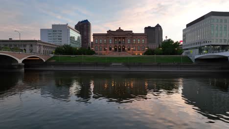 aerial glide over des moines river looking towards world food prize hall of laureates and skyline during beautiful summer sunset