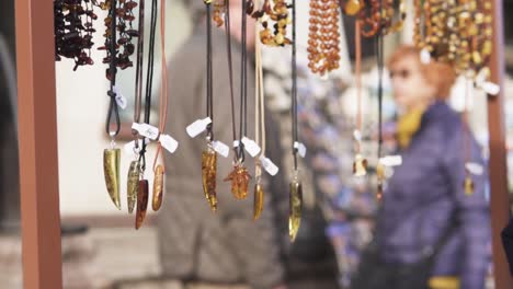 hands getting amber jewelry in slow motion in gdanks, poland