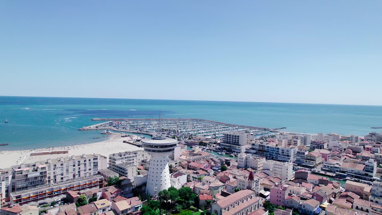 Aerial view of La Grande Motte City with beach,lighthouse and marina during sunny day in France - French Riviera in Background
