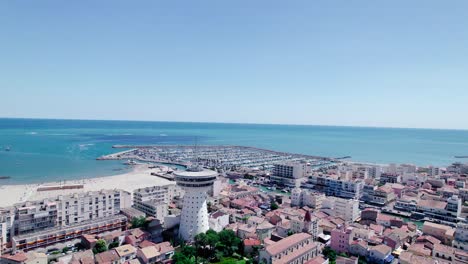 aerial view of la grande motte city with beach,lighthouse and marina during sunny day in france - french riviera in background