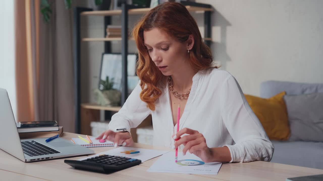 Caucasian woman deals with business analytics sits at desk with laptop