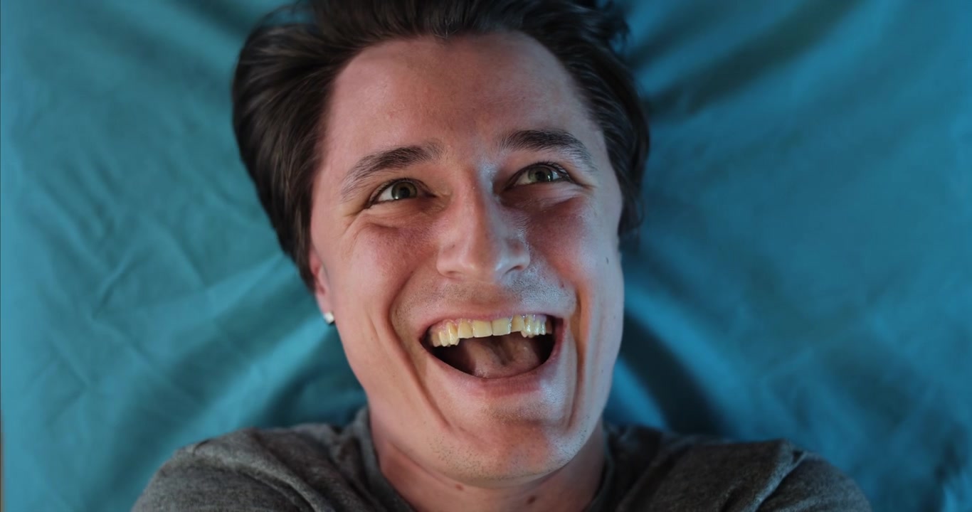 Funny Young Man Laughing and Screaming with Wide Eyes