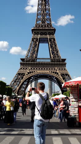 tourist capturing the eiffel tower in paris