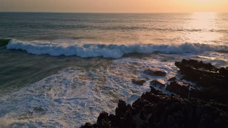 summer ocean splashing sunrise light drone view. sun rays reflecting ripple sea