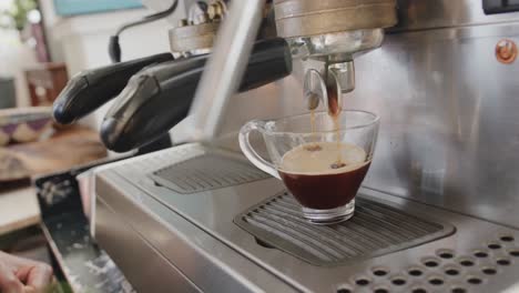 close up of african american barista preparing coffee at coffee shop, slow motion