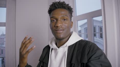 portrait of happy young man recording video with phone camera