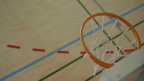 Overhead-view-of-african-american-male-basketball-player-scoring-goal-against-diverse-players