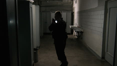 Female-safety-guard-with-flashlight-in-a-warehouse