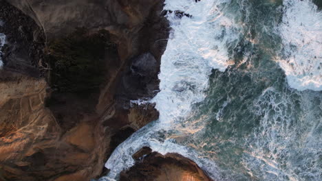 waves crashing into pacific city beach in oregon at sunset