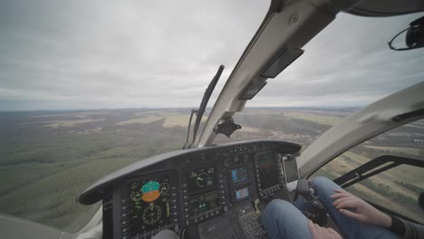 Explore-the-rural-landscape-from-the-first-person-perspective-inside-the-cockpit-of-a-Bell-249-helicopter-as-it-gracefully-flies-above,-offering-a-captivating-aerial-view