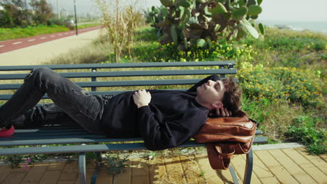 man relaxing in the nature near the sea on a bench