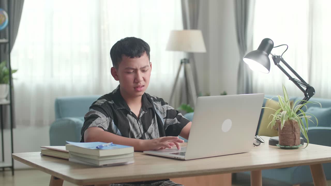 Teenager Studying at Home, Stressed and Tired