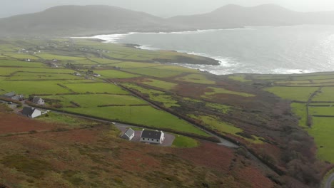 reveal shot of irish landscape with beautiful coastline in background