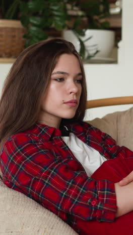 woman with depression disorder at home. sad lady walks through hard breakup with beloved person sitting on papasan chair. mental health state