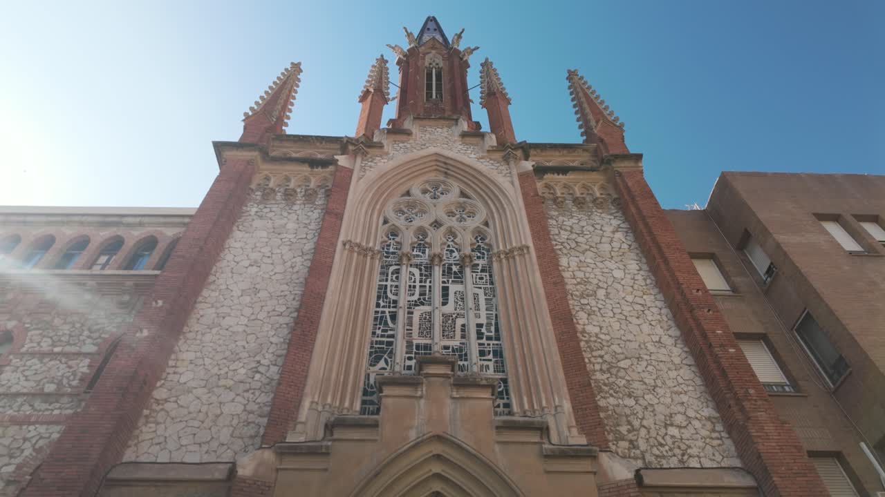 Gothic style facade of the Monastery of the Carmelite Fathers with stained glass in Tarragona Spain