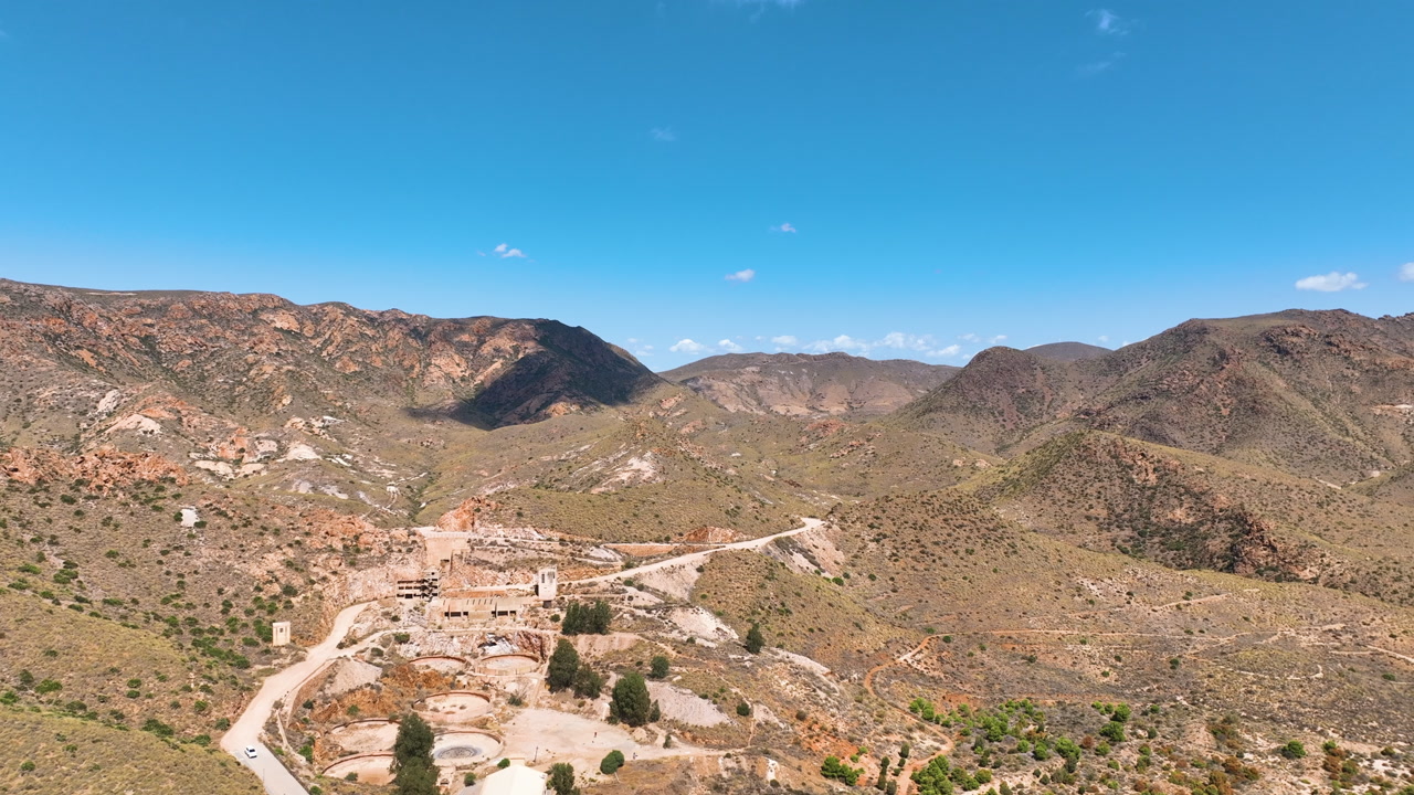 Aerial flies over heritage structures and hills of the Rodalquilar gold mine