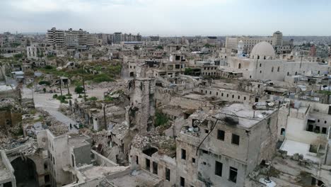 aerial view with a drone over a district in aleppo. we can see the roofs of the buildings in the syrian city in ruins  4k