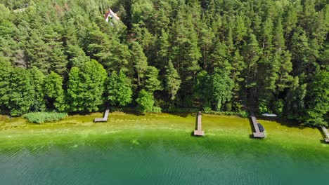 Shoreline-of-typical-kashubian-lake-of-Jezioro-Gwiazdy-in-Borowy-Młyn-in-Kashubia,-Pomeranian-Voivodeship,-Poland