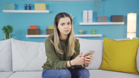 The-young-girl-looking-at-the-phone-looks-at-the-camera-with-a-languid-expression.