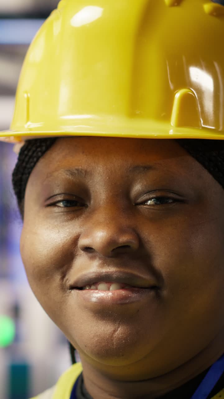 Vertical video Happy engineer in smart photovoltaics factory looking at system performance