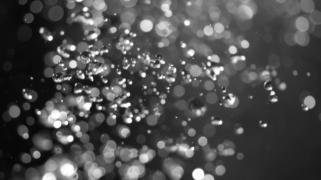 Floating abstract particle bokeh on dark background. Shot on super slow motion camera 1000 fps.