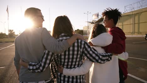 Group-Of-Four-Young-Multirace-Friends-Laughing-While-Walking-Outdoors