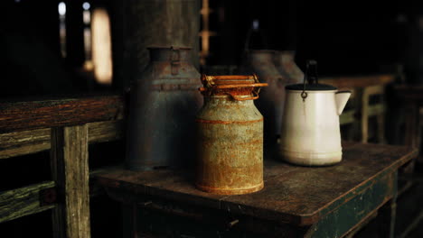 rusty vintage milk cans on old wooden table