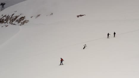 skiers and snowboarders on a snowy mountain slope