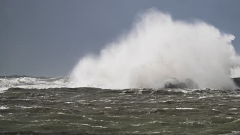 stormy waves crashing against lighthouse